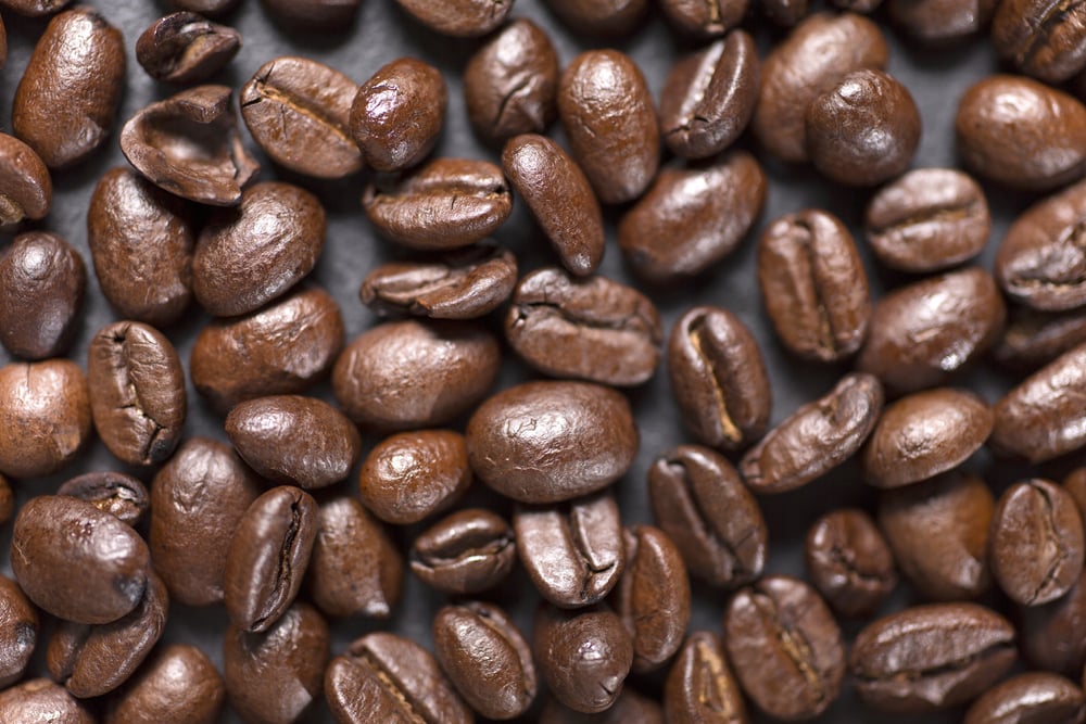 Fresh roasted coffee beans on a black slate surface